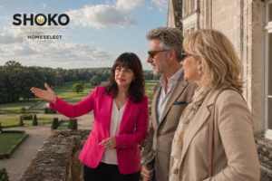 SHOKO reviewing a property shortlist with an international couple on a terrace overlooking the old town and marina of Antibes